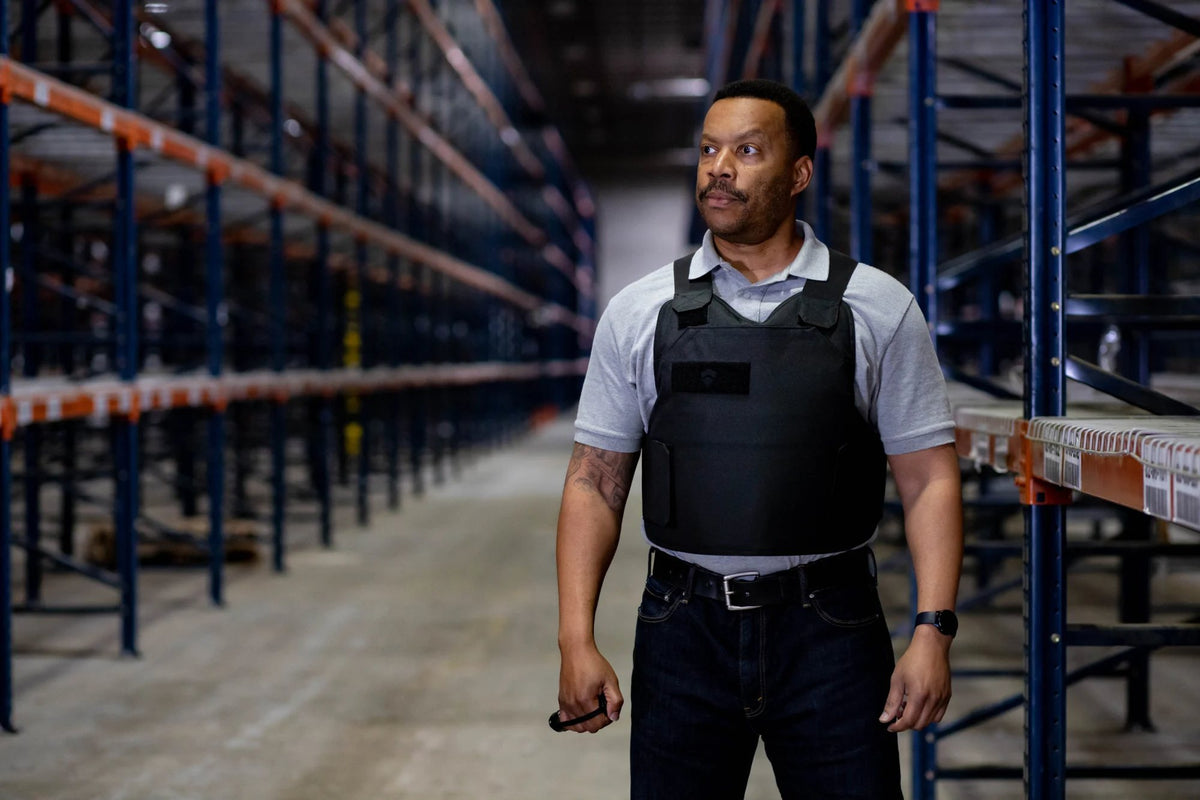 Security officer in a BulletSafe vest on patrol in a warehouse